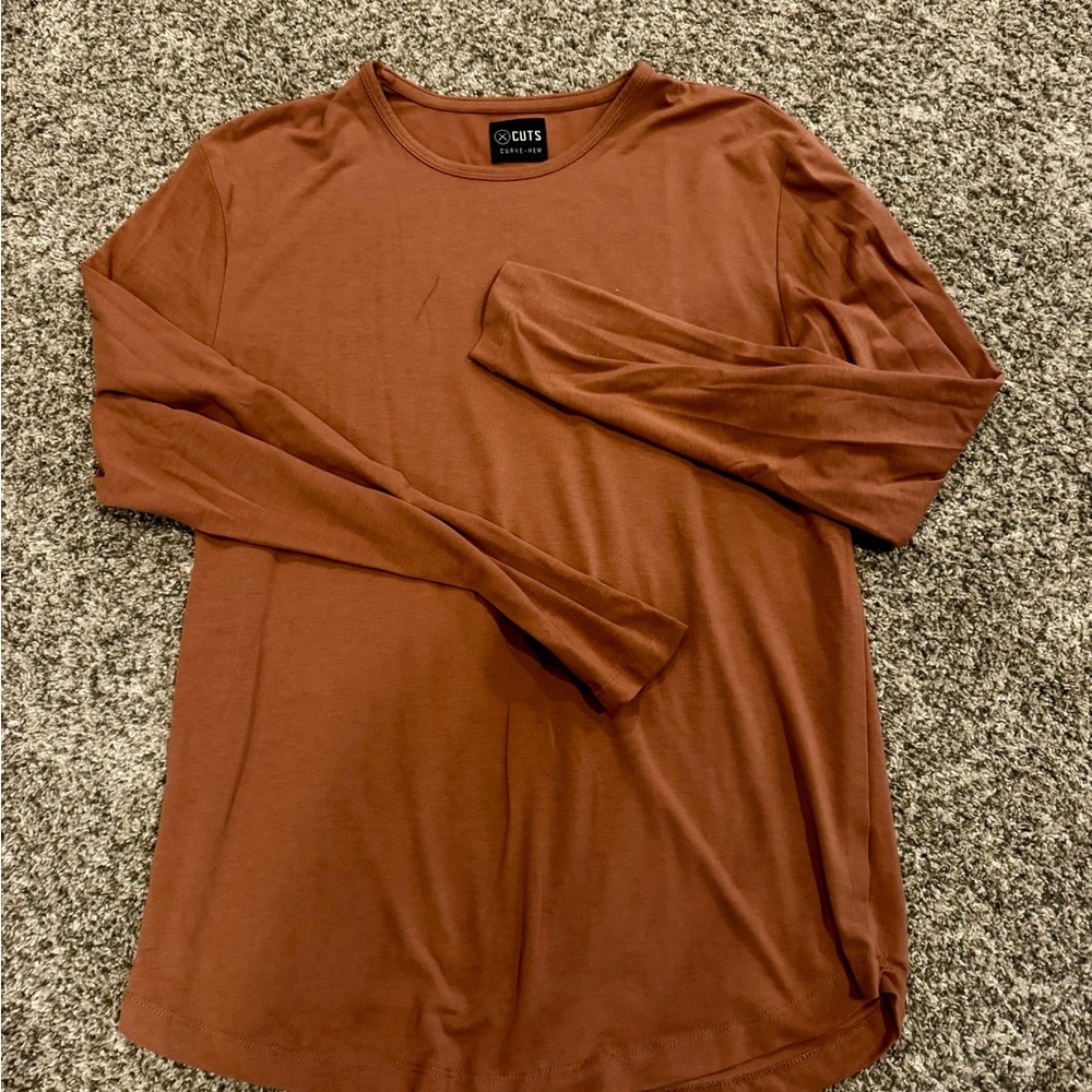 Cuts burnt orange long sleeve. Size M.